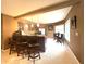 Basement kitchenette with brown cabinetry, stainless steel appliances, and bar stool seating at 9615 N County Road 150 E Rd, Pittsboro, IN 46167