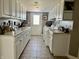This long laundry room has white walls, light cabinets and tile floors at 9615 N County Road 150 E Rd, Pittsboro, IN 46167