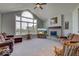 Bright living room featuring a fireplace, large windows, and comfortable seating at 9615 N County Road 150 E Rd, Pittsboro, IN 46167