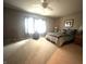 This spacious main bedroom has a ceiling fan, carpeted floors and bright light from the exterior windows at 9615 N County Road 150 E Rd, Pittsboro, IN 46167