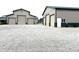 Multiple outbuildings with garage doors and gravel driveway at 9615 N County Road 150 E Rd, Pittsboro, IN 46167