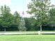 A classic windmill situated between a verdant lawn and picturesque pond at 9615 N County Road 150 E Rd, Pittsboro, IN 46167