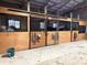 Clean and spacious horse stalls featuring sturdy wood construction and convenient metal bars at 9615 N County Road 150 E Rd, Pittsboro, IN 46167
