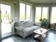 Bright sunroom with tile floors, large windows, and comfortable seating with views of the outdoor scenery at 9615 N County Road 150 E Rd, Pittsboro, IN 46167