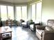 Relaxing sunroom featuring tile flooring, comfortable seating, and multiple windows showcasing the landscape at 9615 N County Road 150 E Rd, Pittsboro, IN 46167