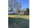 Lush backyard with a variety of sheds and mature trees creating a private, serene outdoor space at 9704 Porter Dr, Avon, IN 46123