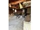 Spacious garage interior featuring exposed beams, wood burning stove and space for storage at 9704 Porter Dr, Avon, IN 46123