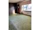 Cozy living room with natural light, featuring paneled walls and a street view at 9704 Porter Dr, Avon, IN 46123