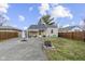 Lush backyard featuring a brick fire pit, a well-maintained lawn, and a covered patio at 1019 Lennox St, Anderson, IN 46012