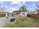 Cozy backyard featuring a brick fire pit, a well-maintained lawn, and a covered patio at 1019 Lennox St, Anderson, IN 46012