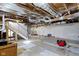 Unfinished basement with exposed utilities, concrete floor, and access to the upper levels at 1019 Lennox St, Anderson, IN 46012