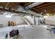 Unfinished basement with exposed wood beams, ductwork, and stairs to the upper level at 1019 Lennox St, Anderson, IN 46012