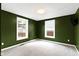 Cozy bedroom with new carpet, two windows, and neutral walls at 1019 Lennox St, Anderson, IN 46012