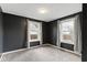 Bedroom boasting dark-painted walls, two windows with bright light, and gray carpet for a calm and inviting space at 1019 Lennox St, Anderson, IN 46012