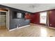 Living room with bar area, TV, and new wood look floors at 1019 Lennox St, Anderson, IN 46012