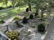 A beautifully landscaped backyard with stone pavers and lush greenery at 1020 W Riverview Dr, Anderson, IN 46011