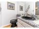 Stylish powder room featuring a black sink, granite countertop, and decorative wall art at 1020 W Riverview Dr, Anderson, IN 46011