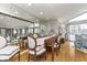 Bright dining room with mirrored wall, hardwood flooring, and view to the backyard at 1020 W Riverview Dr, Anderson, IN 46011