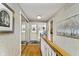 Bright hallway featuring hardwood floors and staircase leading to additional rooms at 1020 W Riverview Dr, Anderson, IN 46011