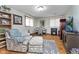 Cozy living room featuring hardwood floors, a decorative fireplace, and comfortable seating arrangement at 1020 W Riverview Dr, Anderson, IN 46011