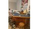 Basement wet bar featuring beautiful tiled countertops and a cozy seating area for entertaining at 11215 Cowan Lake Ct, Indianapolis, IN 46235
