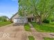 Charming home featuring a well-manicured lawn, inviting porch, and attached two-car garage at 11215 Cowan Lake Ct, Indianapolis, IN 46235
