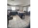 Well-lit kitchen with white cabinets, contrasting island, tile backsplash, and stainless steel appliances at 11215 Cowan Lake Ct, Indianapolis, IN 46235