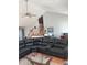 Spacious living room featuring a large leather sectional, a ceiling fan, and stairs to an upper level at 11215 Cowan Lake Ct, Indianapolis, IN 46235