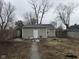 Backyard view of the detached house with a plain, small backyard with dead leaves at 1126 N Mitthoeffer Rd, Indianapolis, IN 46229