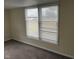 A cozy bedroom featuring neutral carpet and natural light from large windows at 1126 N Mitthoeffer Rd, Indianapolis, IN 46229