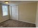 The bedroom offers carpet flooring, a window for natural light, and a double door closet at 1126 N Mitthoeffer Rd, Indianapolis, IN 46229