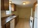 A functional kitchen featuring a stainless steel sink and neutral tile floors at 1126 N Mitthoeffer Rd, Indianapolis, IN 46229