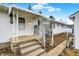 A charming back porch with awning leads to a white home under a sunny sky at 1157 Evans Ave, Noblesville, IN 46060