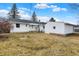 A large backyard features a white house with a detached garage under a blue sky at 1157 Evans Ave, Noblesville, IN 46060