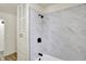 Close up of bathroom tiled shower and bathtub with matte black shower head and faucet at 1157 Evans Ave, Noblesville, IN 46060