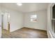 Bright bedroom featuring hardwood floors, white walls, and natural light from the window at 1157 Evans Ave, Noblesville, IN 46060