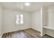 Bedroom with hardwood floors, white painted walls, built in shelves, and window with view at 1157 Evans Ave, Noblesville, IN 46060
