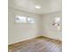 Empty room with hardwood floors, three windows, and neutral painted walls at 1157 Evans Ave, Noblesville, IN 46060