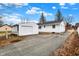 Exterior view of the property featuring a detached garage with driveway under a blue sky at 1157 Evans Ave, Noblesville, IN 46060