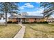Charming brick ranch home featuring a well-manicured lawn and inviting walkway at 1157 Evans Ave, Noblesville, IN 46060