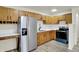Well-lit kitchen featuring stainless steel appliances, wooden cabinetry, and ample countertop space at 1157 Evans Ave, Noblesville, IN 46060