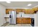 Well-lit kitchen featuring stainless steel appliances, wooden cabinetry, and ample countertop space at 1157 Evans Ave, Noblesville, IN 46060