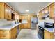 A traditional kitchen featuring light countertops, stainless steel appliances, and wood cabinetry at 1157 Evans Ave, Noblesville, IN 46060
