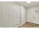 Mud room with wood paneled walls, wood flooring and an exterior door at 1157 Evans Ave, Noblesville, IN 46060