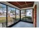 A relaxing sunroom offering natural light and views of the surrounding neighborhood at 1157 Evans Ave, Noblesville, IN 46060