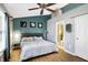 Bedroom with a moon-themed accent wall, natural light and ensuite bathroom at 12601 Slippery Rock Rd, Indianapolis, IN 46236