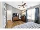 Bedroom with wood floors, a dresser, and natural light from a large window at 12601 Slippery Rock Rd, Indianapolis, IN 46236