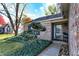 Inviting front entrance with brick facade, tidy landscaping, and a decorative evergreen tree at 12601 Slippery Rock Rd, Indianapolis, IN 46236