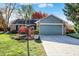 Charming brick home with a well-kept lawn, colorful landscaping, and an attached two-car garage at 12601 Slippery Rock Rd, Indianapolis, IN 46236