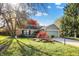 Charming single-story brick home featuring a well-manicured lawn and mature trees at 12601 Slippery Rock Rd, Indianapolis, IN 46236